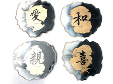 Load image into Gallery viewer, Geode Shaped Coaster with Chinese Characters in White, Black, and Gold.  Love, Goodwill, Peace, and Joy
