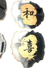 Load image into Gallery viewer, Geode Shaped Coaster with Chinese Characters in White, Black, and Gold.  Love, Goodwill, Peace, and Joy
