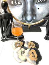 Load image into Gallery viewer, Geode Shaped Coaster with Chinese Characters in White, Black, and Gold.  Love, Goodwill, Peace, and Joy
