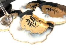 Load image into Gallery viewer, Geode Shaped Coaster with Chinese Characters in White, Black, and Gold.  Love, Goodwill, Peace, and Joy
